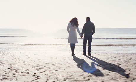 couple holding hands on the beach
